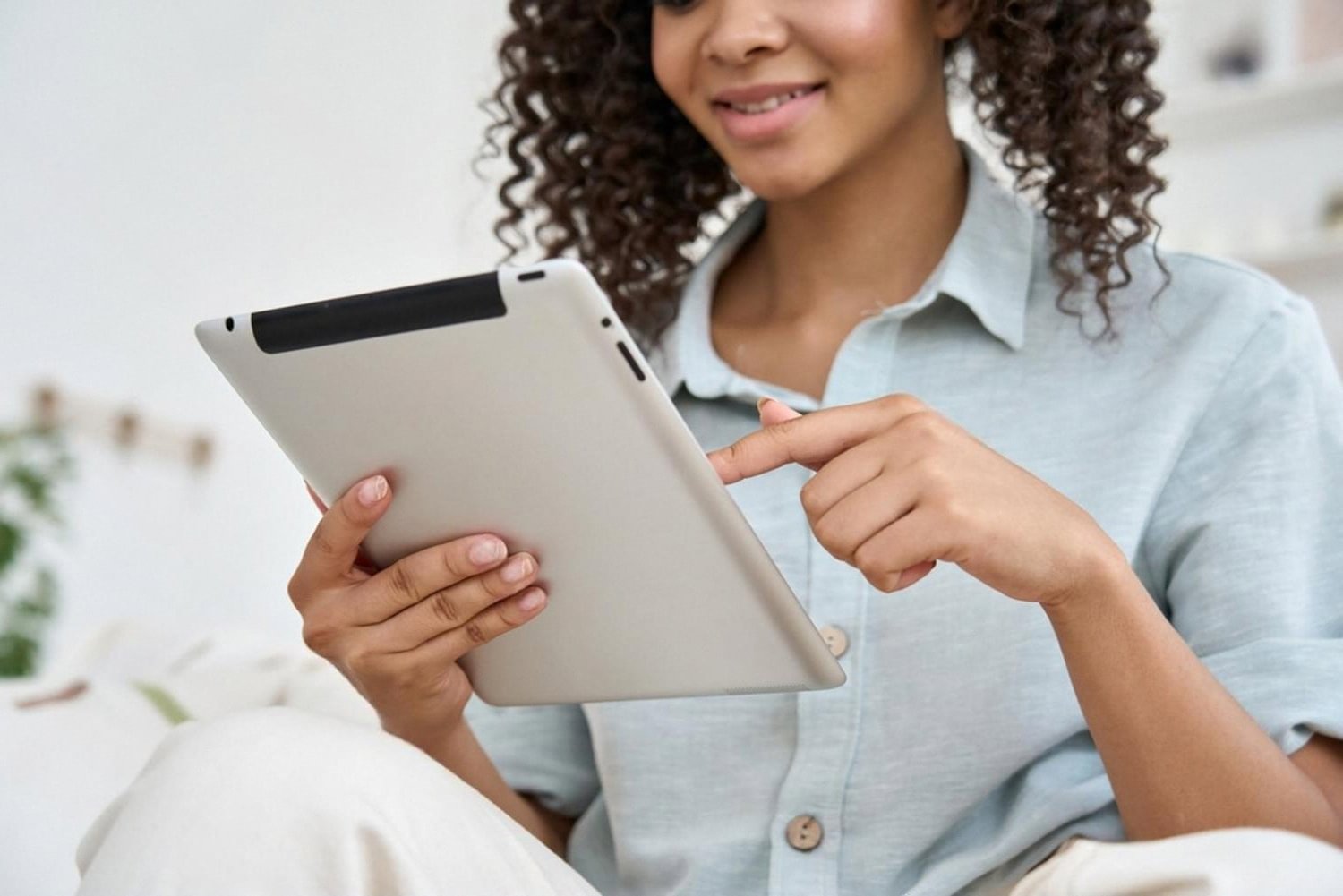 Young woman reviewing a rental listing on a tablet before booking in the UAE