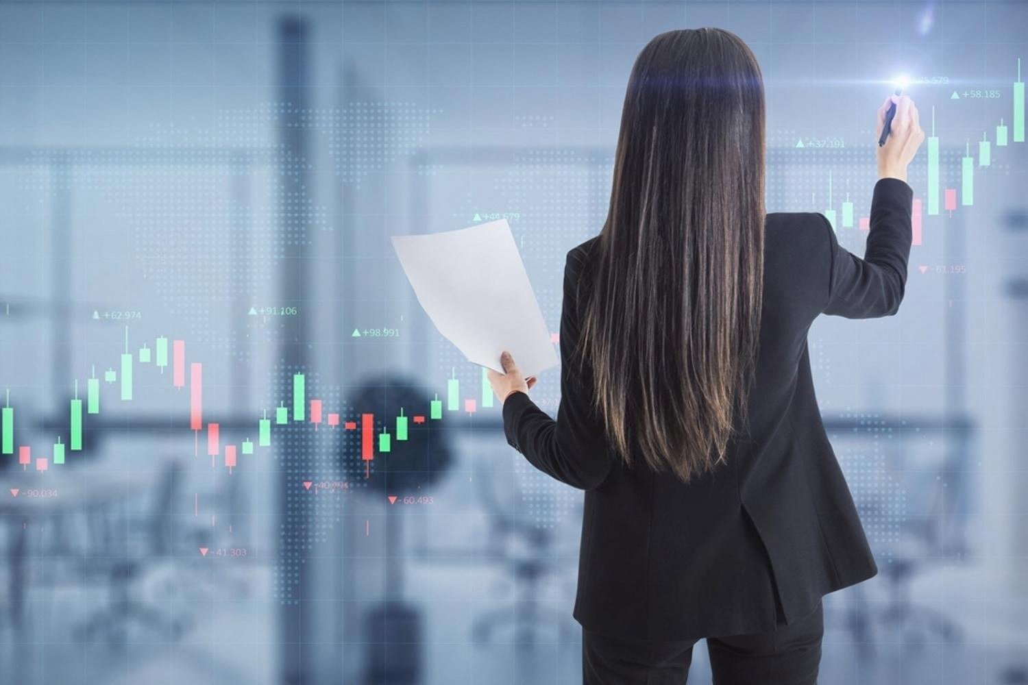 Business manager analysing performance charts on a digital dashboard in a Dubai office